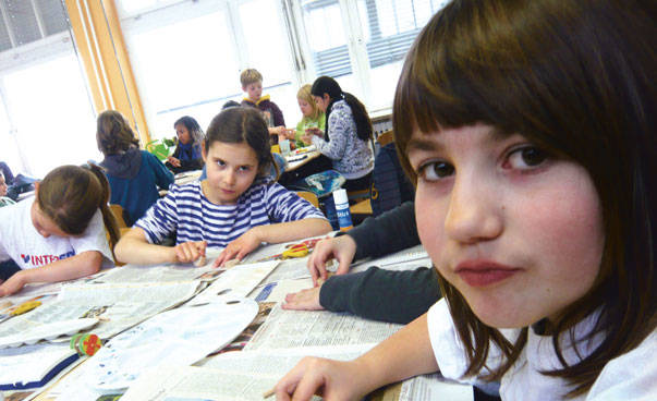 Pupils in a class room working on a project about global learning.